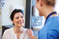 Mujer sonriendo en consulta con médico